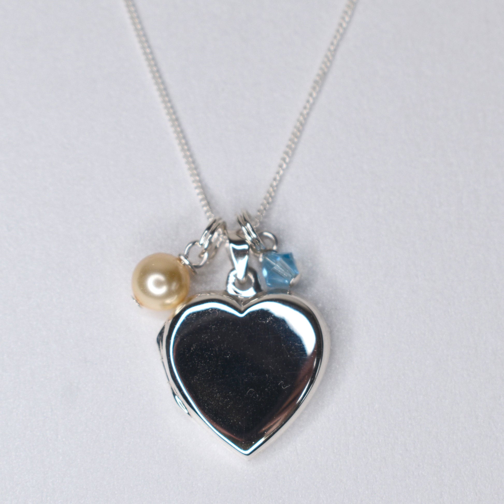 Sterling silver heart locket with cream  pearl and blue crystal