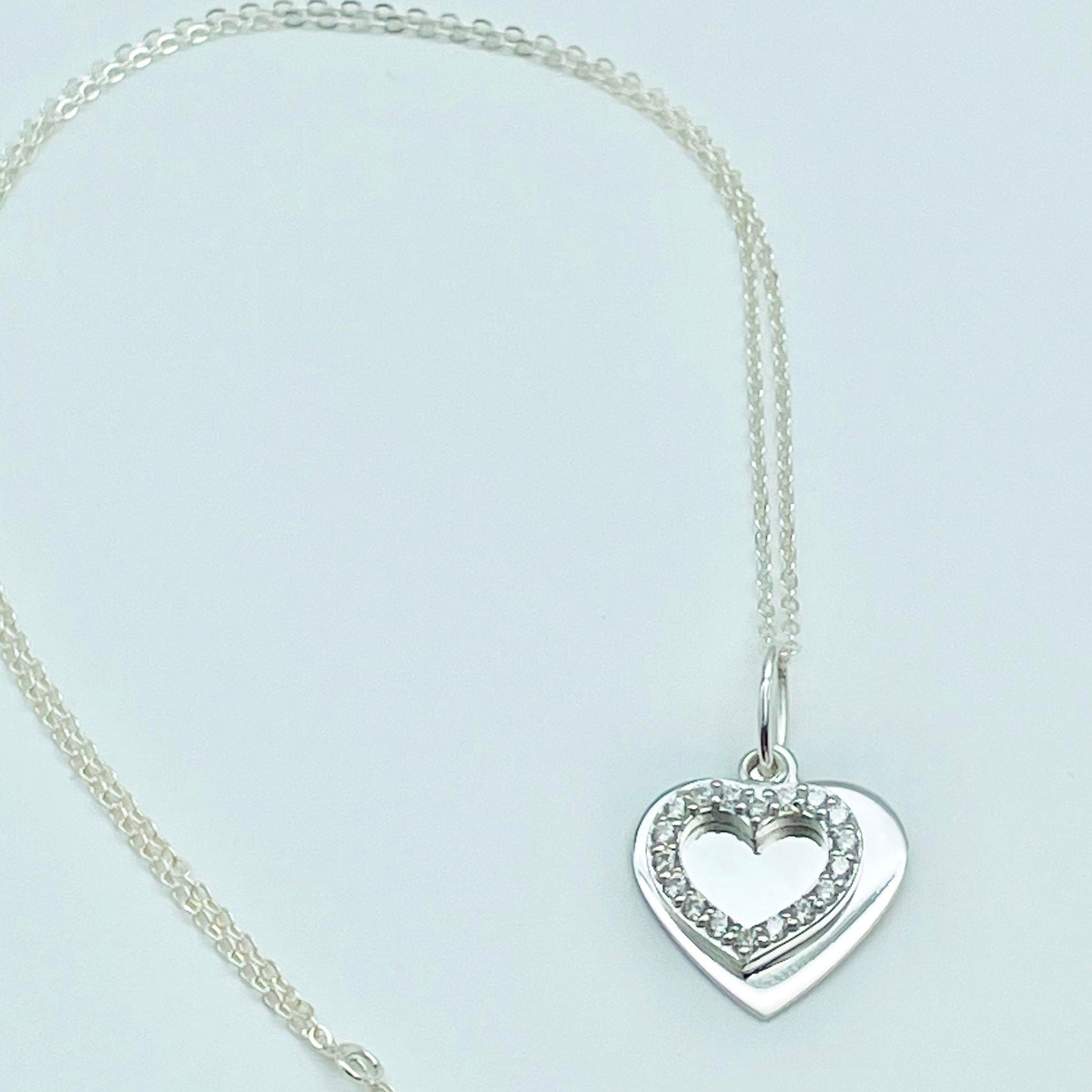Sparkling Silver Double Heart Necklace | Personalised Message in atwo hearts, one sterling silver and the other an open heart of cubic zircona hung from a sterling slver chain