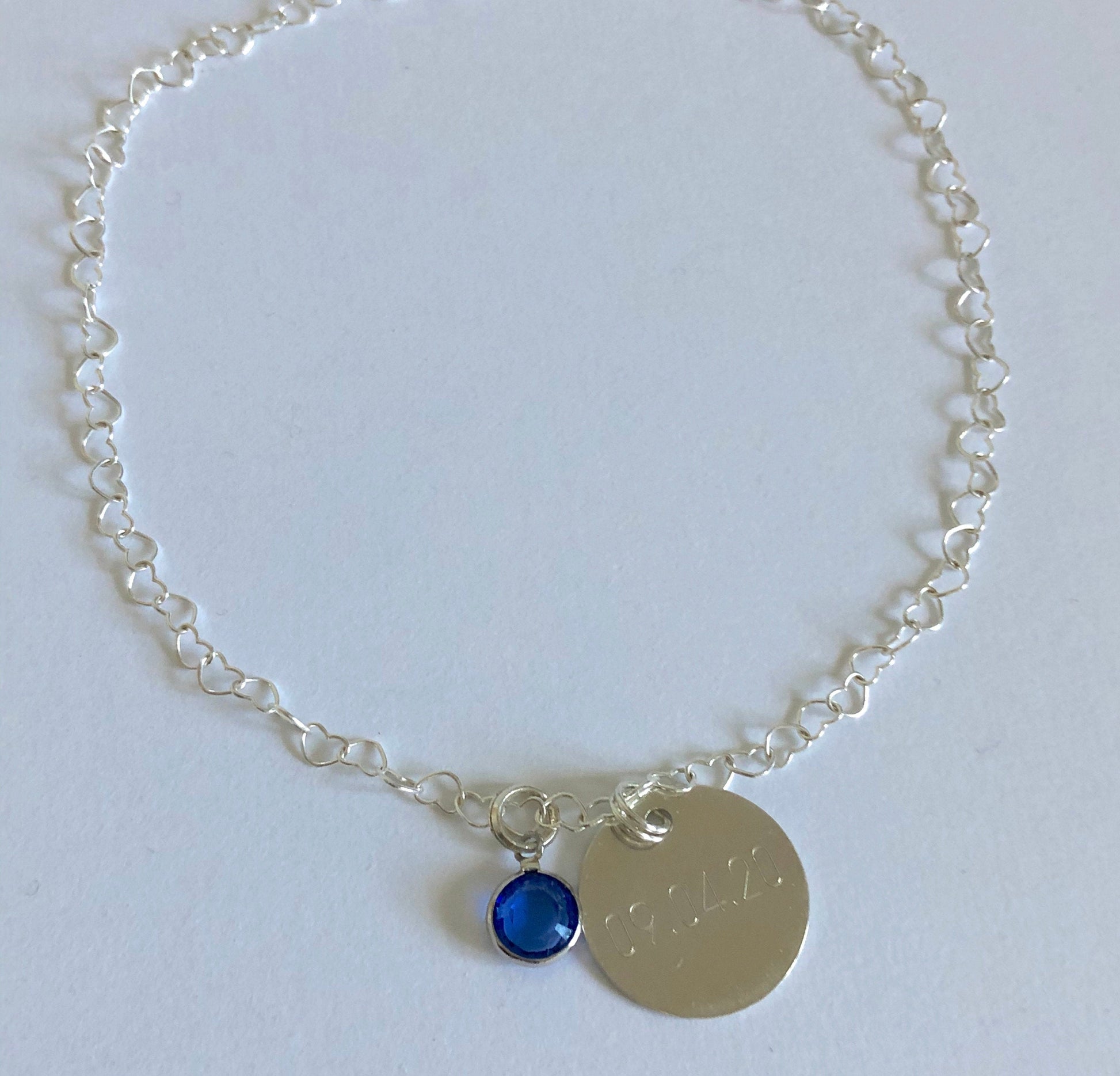 anklet with heart shaped links, blue stone and optional tag showing wedding date