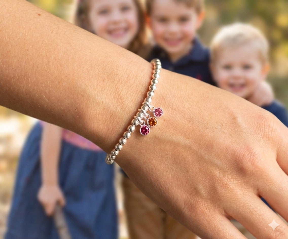 Sterling silver beaded bracelet of 4mm beads threaded onto strong elastic with three birthstones. Up to five birthstones can be added to this bracelet