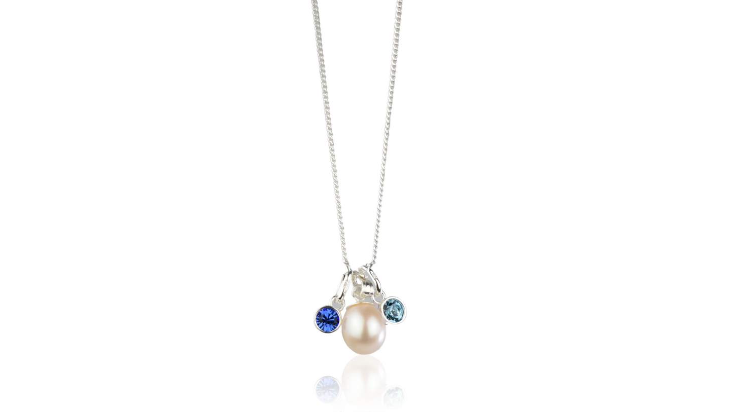 Pearl drop necklace shown with two crystal birthstones