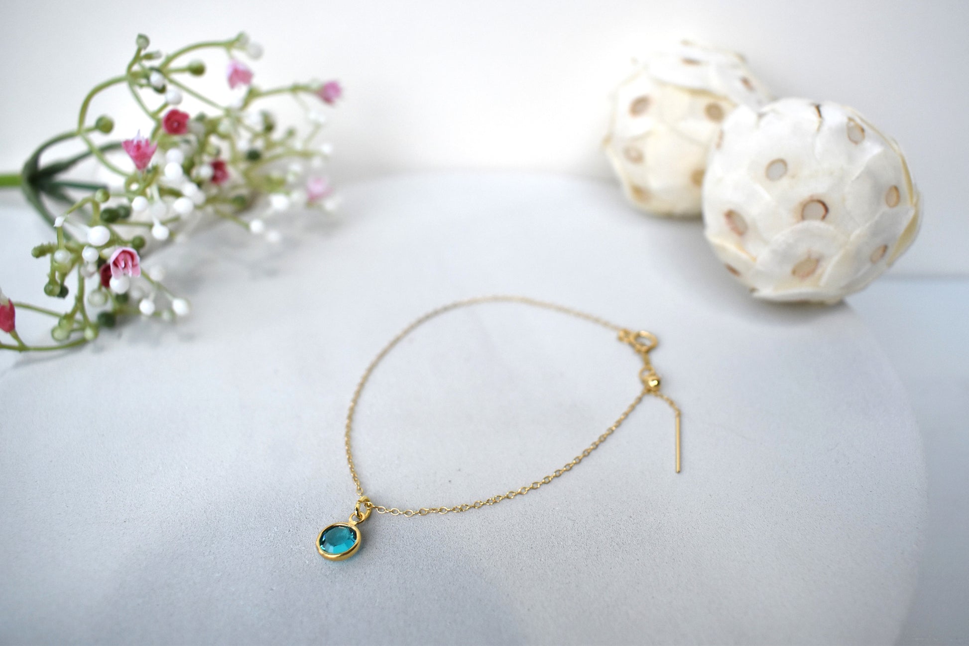 A gold filled chain is  threaded through a bead to make this delicate bracelet adjustable. Finished with a birthstone of your choice, ths bracelet is the perfect summer accessory.