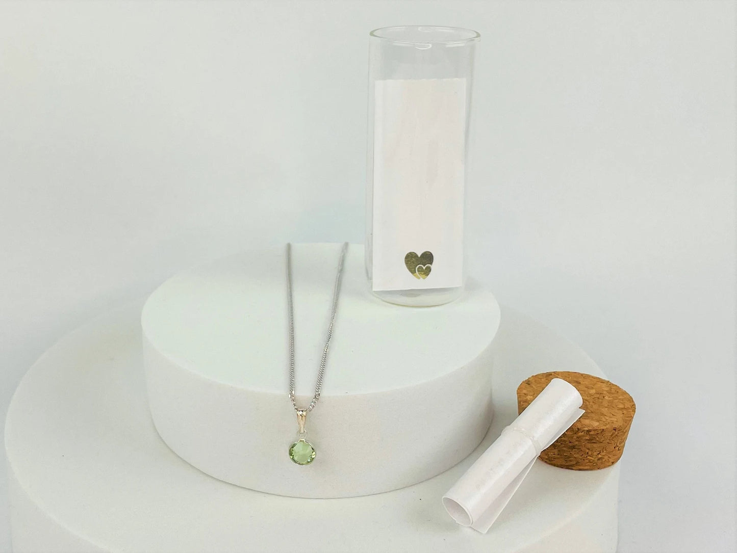 Peridot birthstone on sterling silver chain. Shown in presentation bottle
