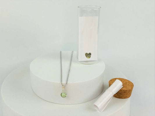 Peridot birthstone on sterling silver chain. Shown in presentation bottle