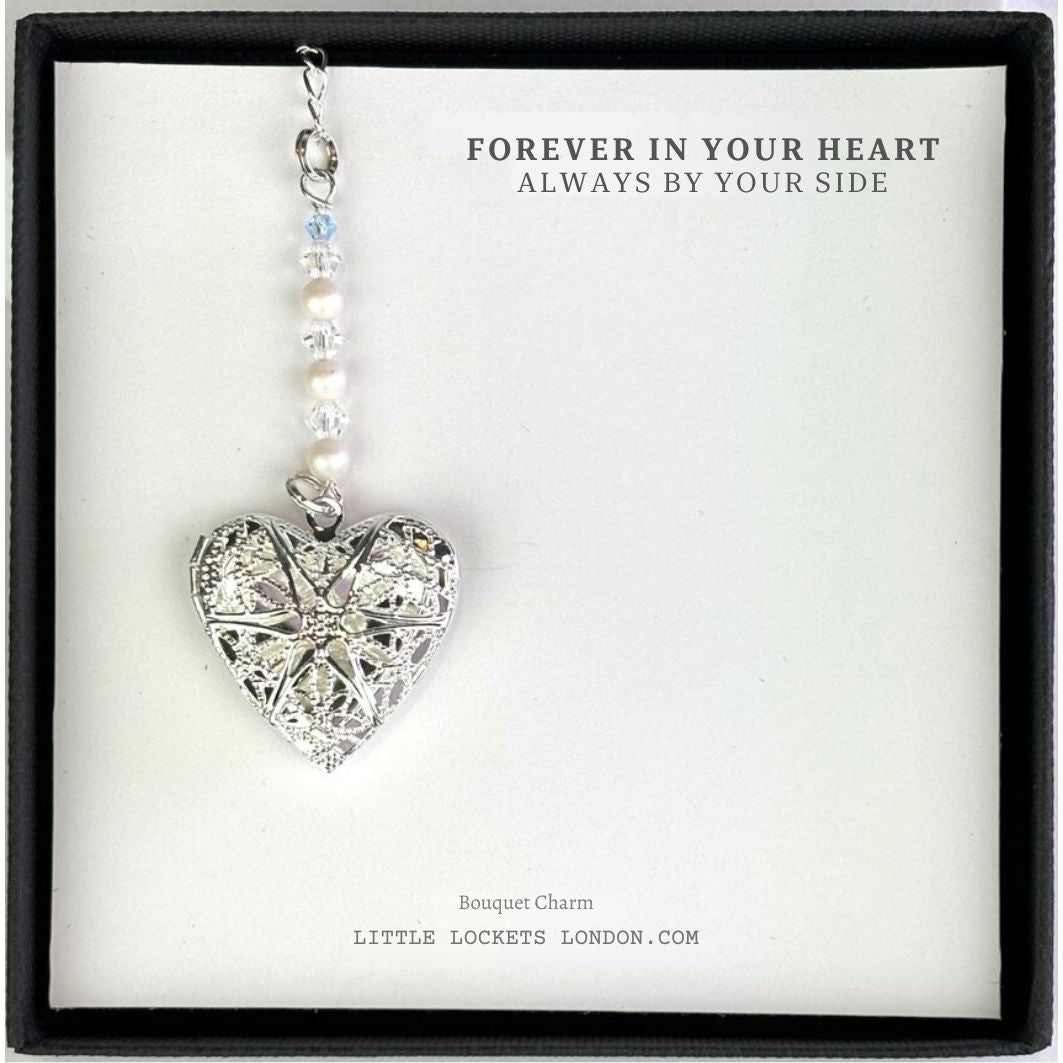 Filigree heart locket suspended from glass pearls and crystals with a tiny blue bead shown in gift box with the wording Forever in your heart, always by your side