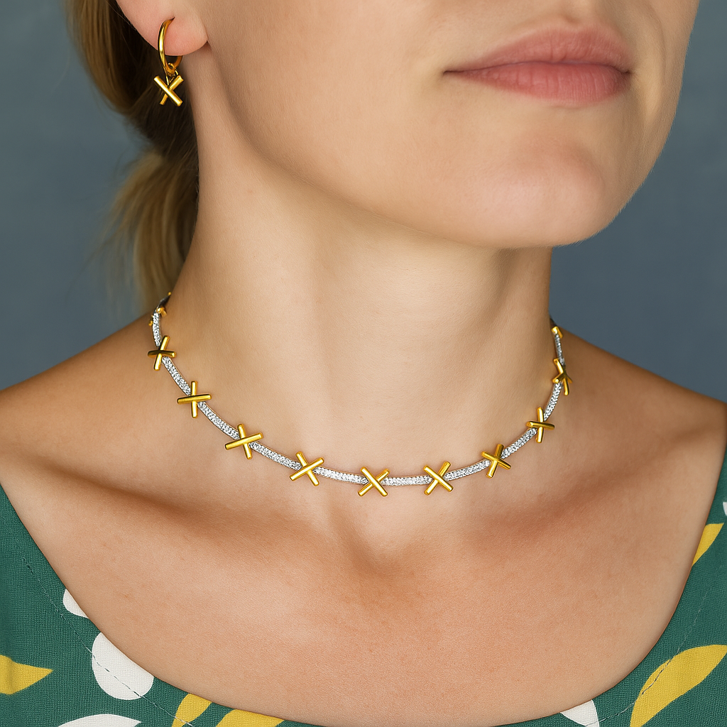 A delicate sterling silver necklace with gold plated kiss charms separated by sparkling CZ stones. Comes with small extension chain