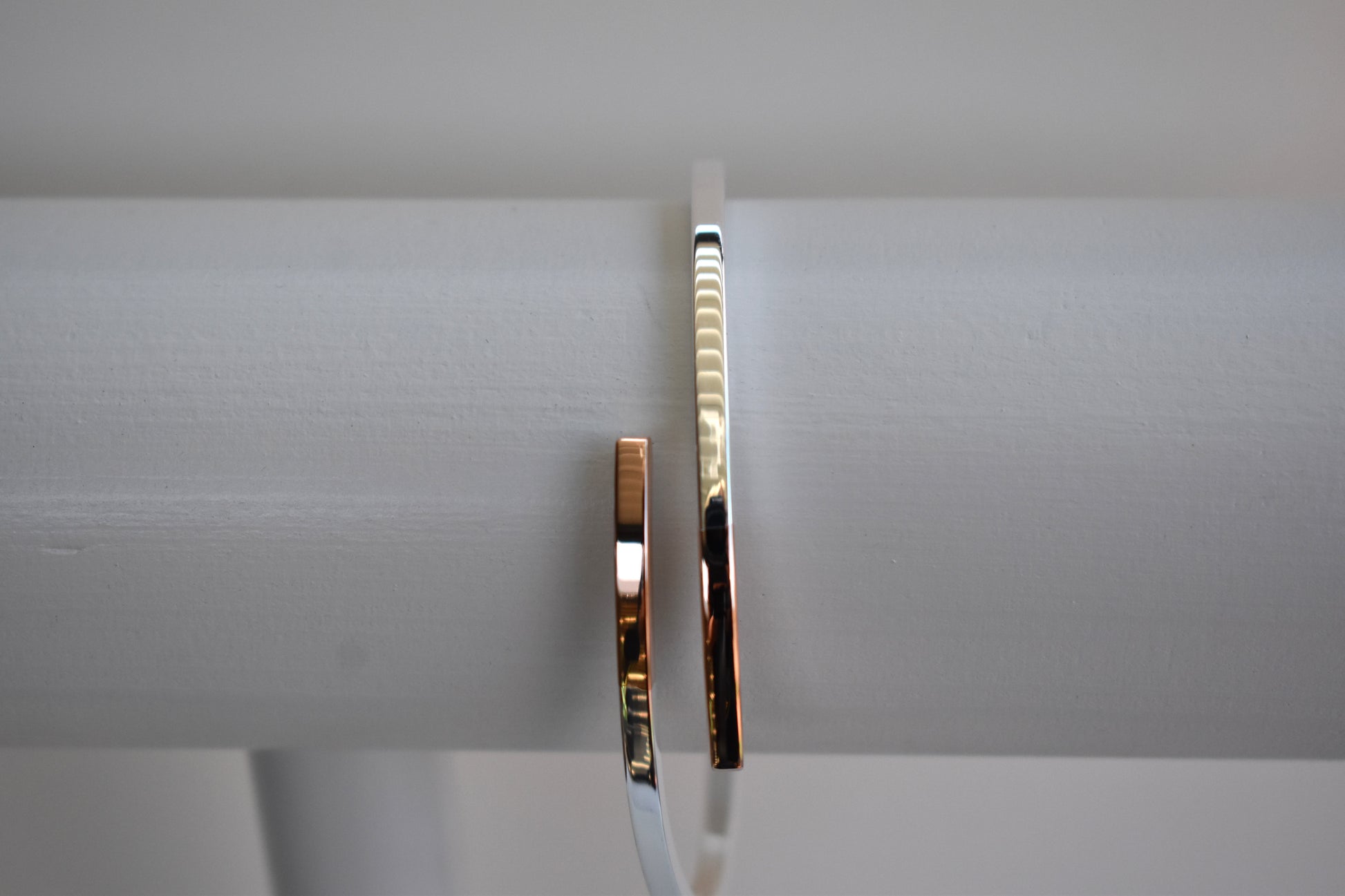 Sterling silver cross over bangle with rose gold tipped ends
