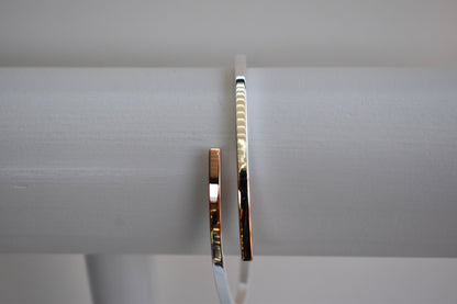 Sterling silver cross over bangle with rose gold tipped ends

