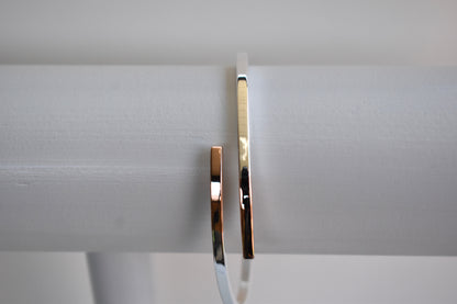 Sterling silver cross over bangle with rose gold tipped ends
