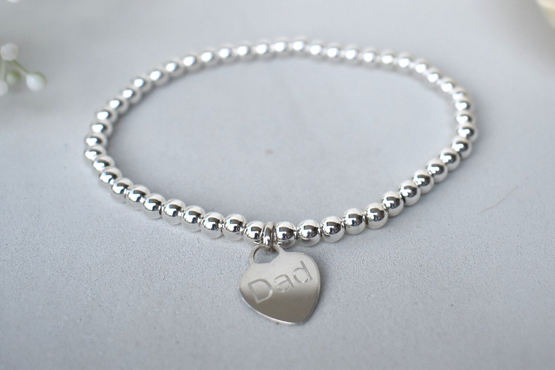 Personalised silver beaded elastic bracelet with engraved sterling silver heart charm, custom name or date, sterling silver shown