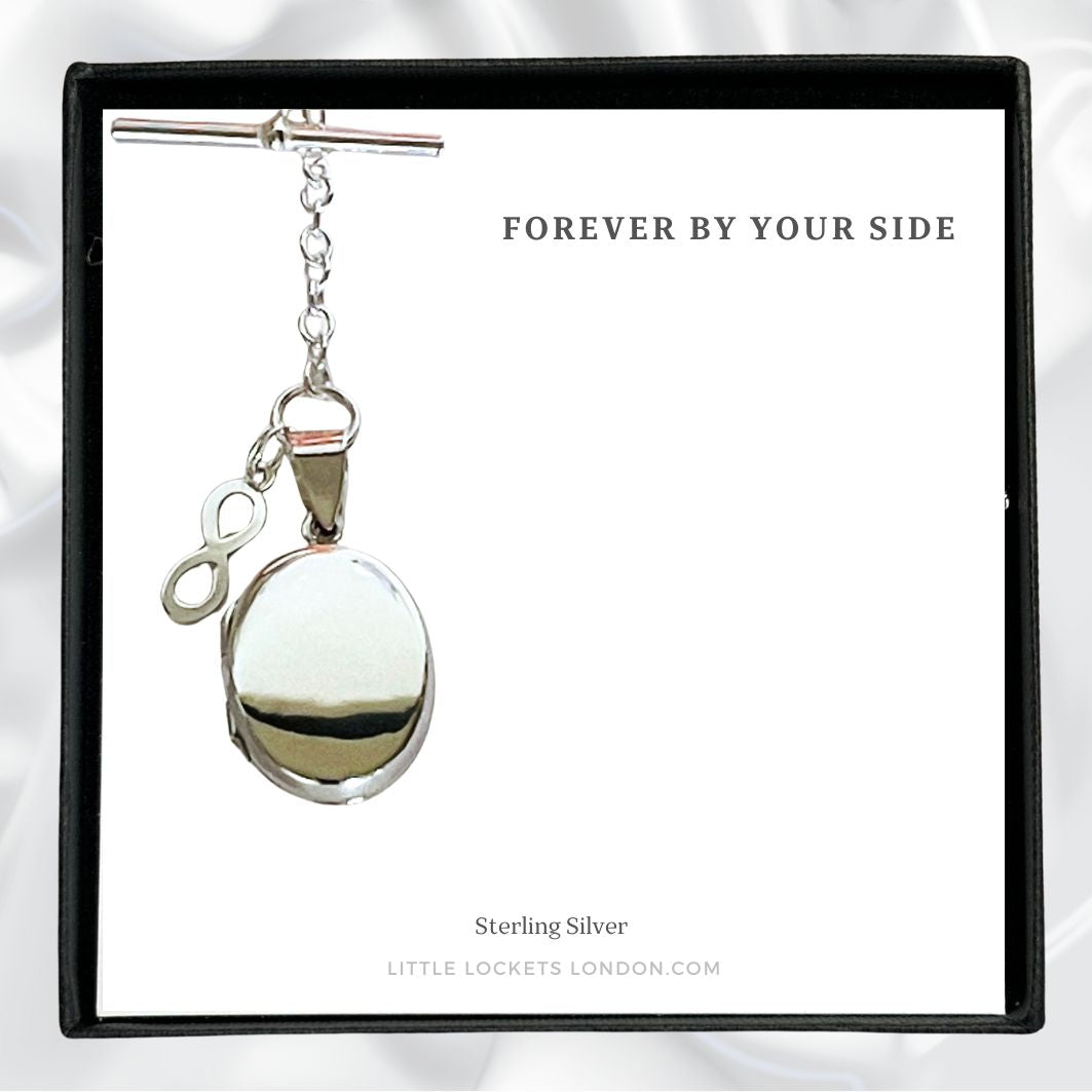 Sterling silver oval locket suspended by T-bar and with attached infinity symbol. Placed in gift box with the message Forever by your side.