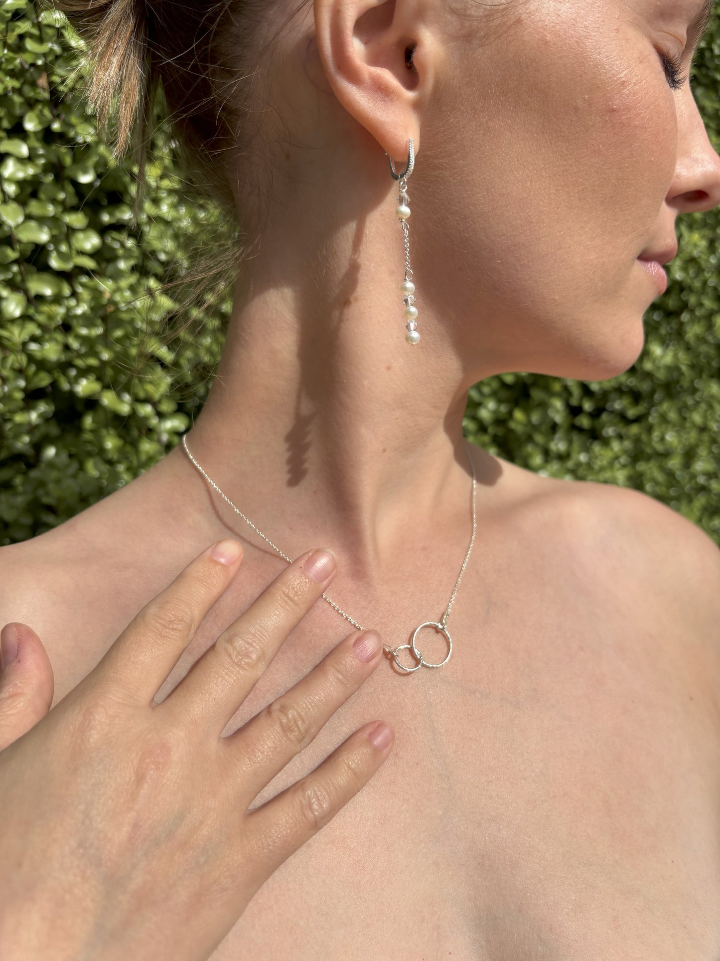 Sterling silver sparkly entwined circles shown on sterling silver chain.
