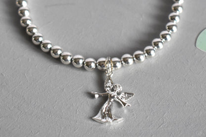 Close up of Sterling silver beaded bracelet with 4mm beads and a 16mm sterling silver angel charm