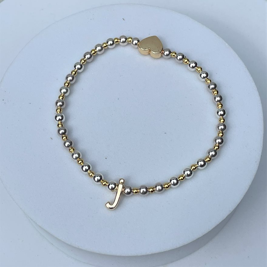 Gold and silver plated beads surround a gold colour lower case initial which sits opposite a gold plated heart, to form this stacker bracelet.