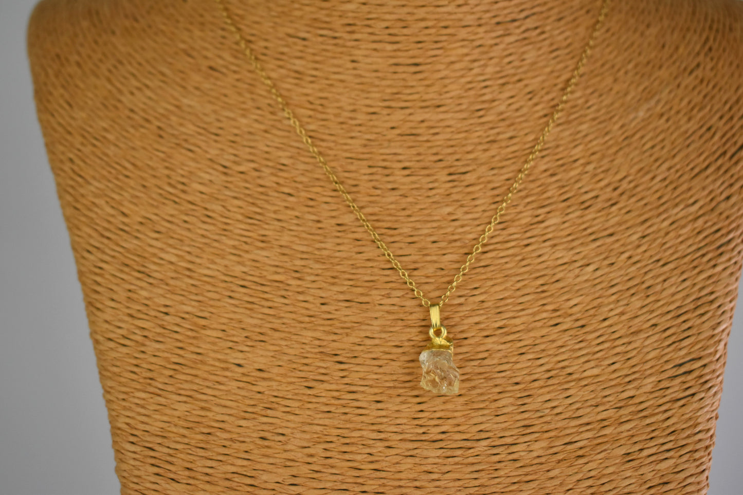 citrine raw crystal shown with sterling silver gold plated tip and suspended from a sterling silver gold plated chain