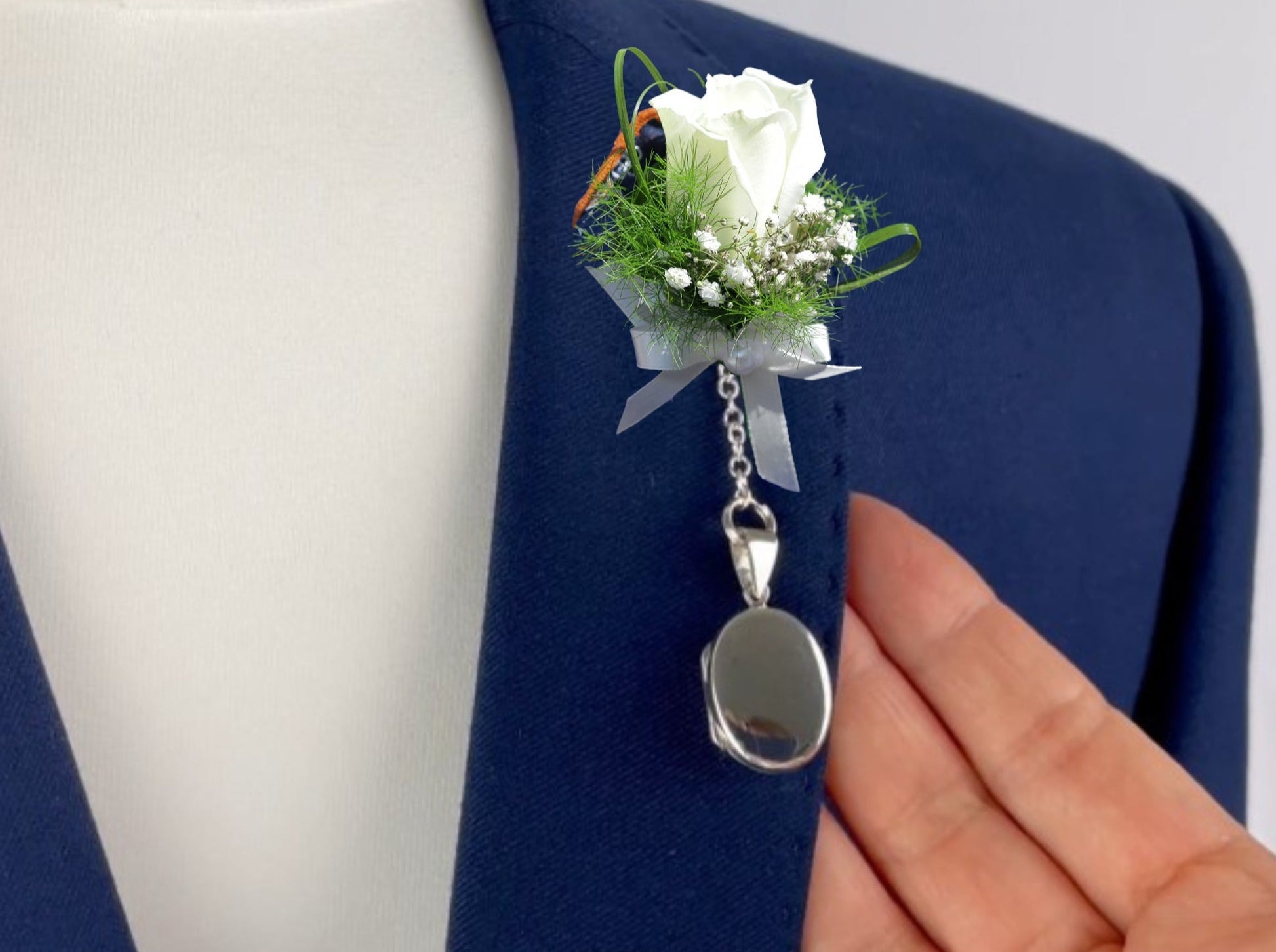 Sterling Silver contemporary Men's Oval Photo Locket. The locket is oval design, can hang from a lapel, inside a jacket pocket, or alongside a buttonhole. Holds up to two photos. Choose between a t-bar or spring clasp.