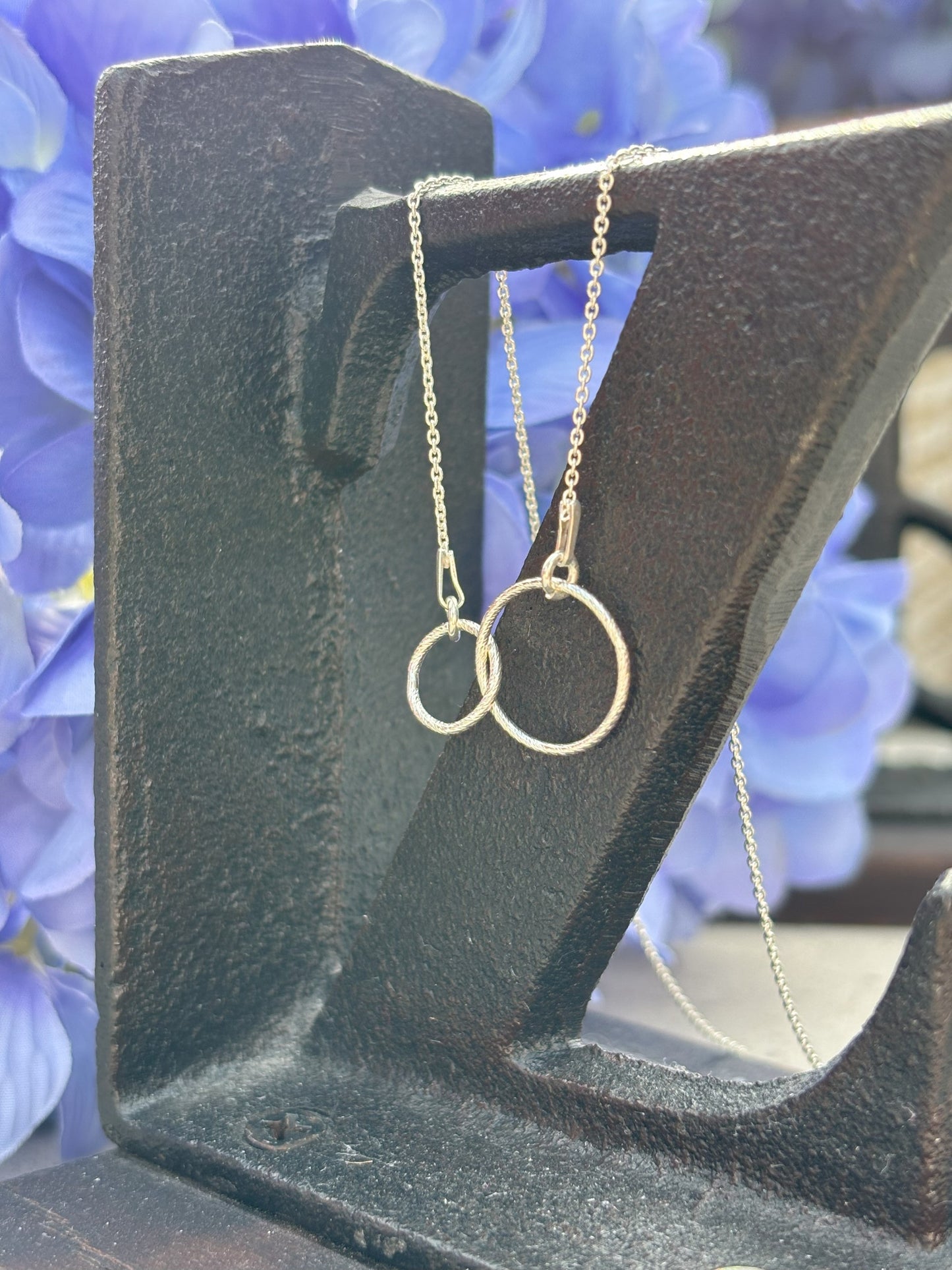 Sterling silver sparkly entwined circles shown on sterling silver chain.