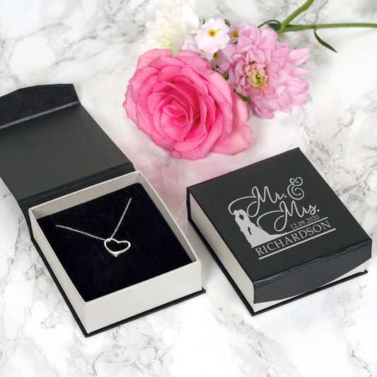 A sterling silver heart pendant suspended from an 18" sterling silver chain and presented in a gift box personalised with the couple's surname and wedding date