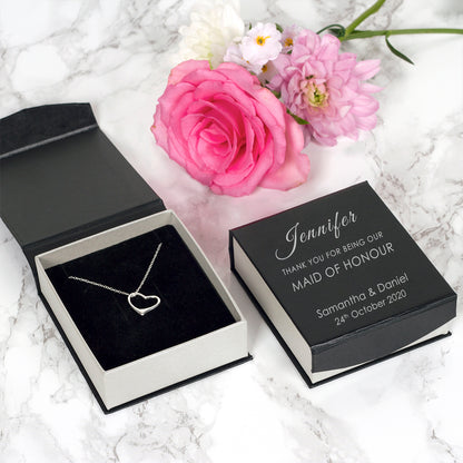 Sterling silver heart suspended from a sterling silver chain and placed in a gift box. The box is personalised with the name of the recipient, their role in the wedding and the couple's names and wedding date.