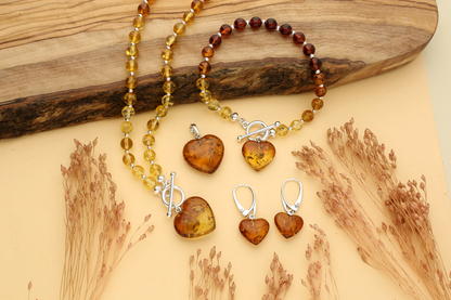 Cognac amber bead collection - graduated amber bead bracelet with amber heart charm, matching graduated amber bead necklace, cognac amber heart pendant with sterling silver bail and sterling silver lever gack hearings with a dangling cognac amber heart.
