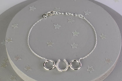 Sterling silver bracelet with cubic zircona horseshoe link. Adjustable by 1 inch extender.