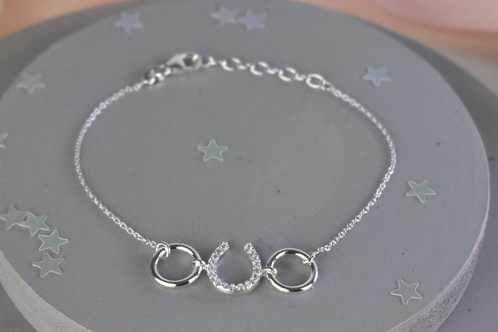 Sterling silver bracelet with cubic zircona horseshoe link. Adjustable by 1 inch extender.
