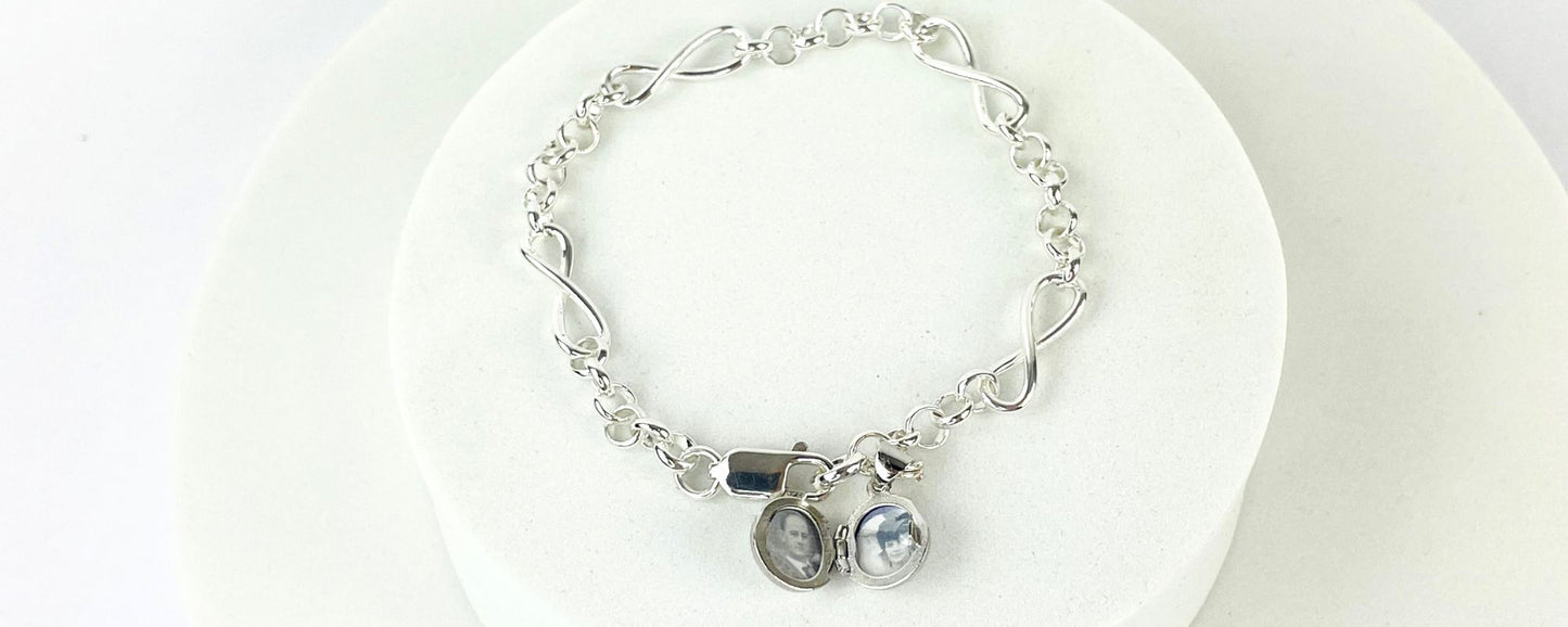 Sterling silver bracelet interspersed with three sterling silver infinity charms and with a tiny opening locket for you to add the photo of your choice. - shown with open locket