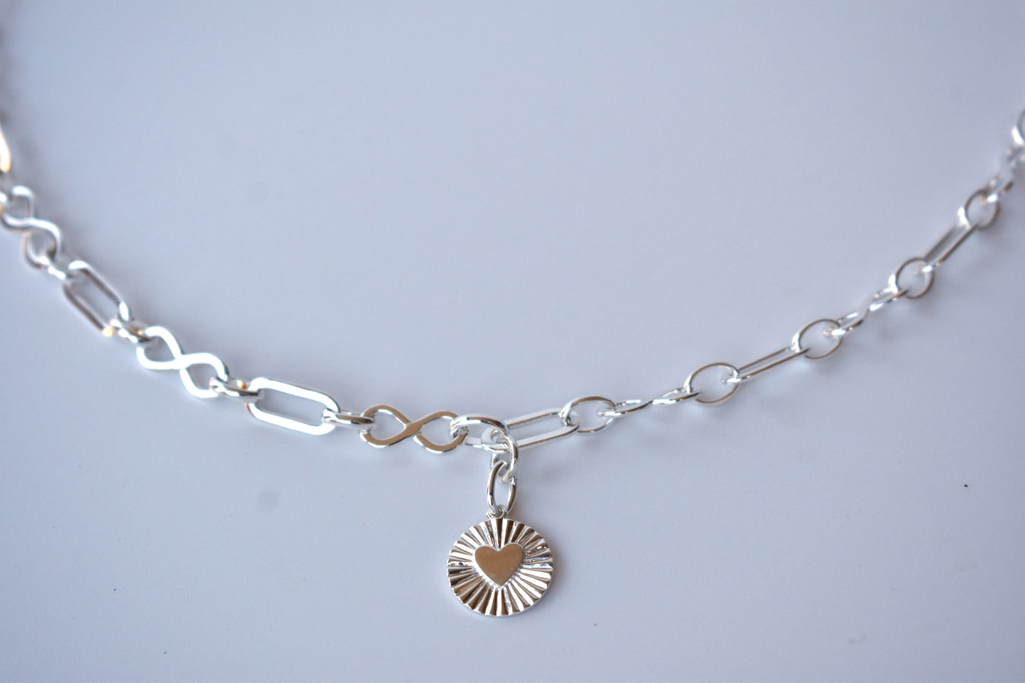 Sterling silver infinity link necklace with sunburst pendant