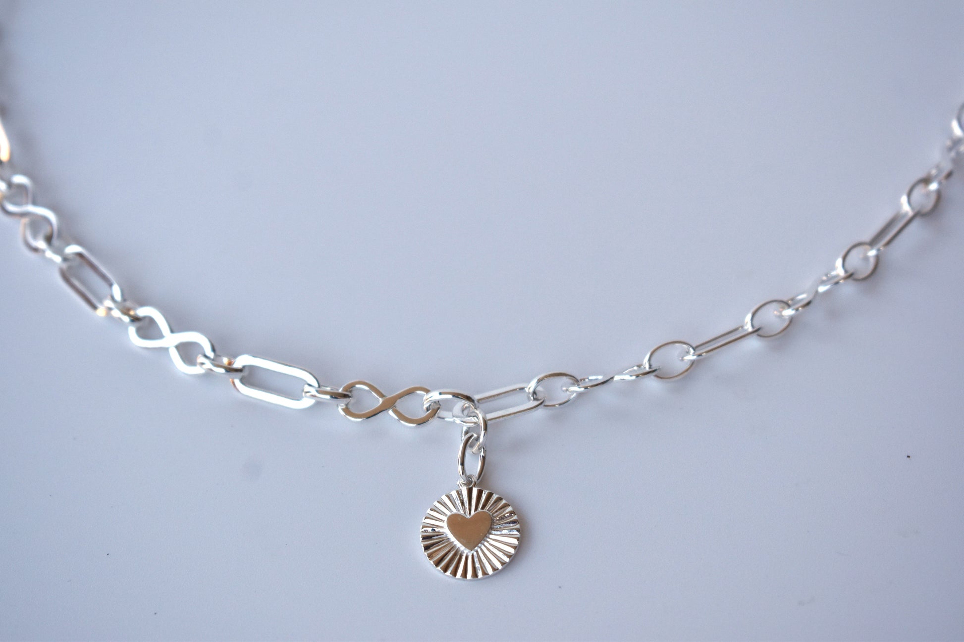 Sterling silver infinity link necklace with sunburst pendant