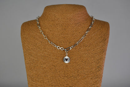 Sterling Silver Handmade Flat Link Infinity Necklace featuring a Heart Rays Pendant. Showcases flat oval and infinity links and features a Sterling Silver Sunburst Heart Rays charm pendant surrounded by an intricate sun rays design