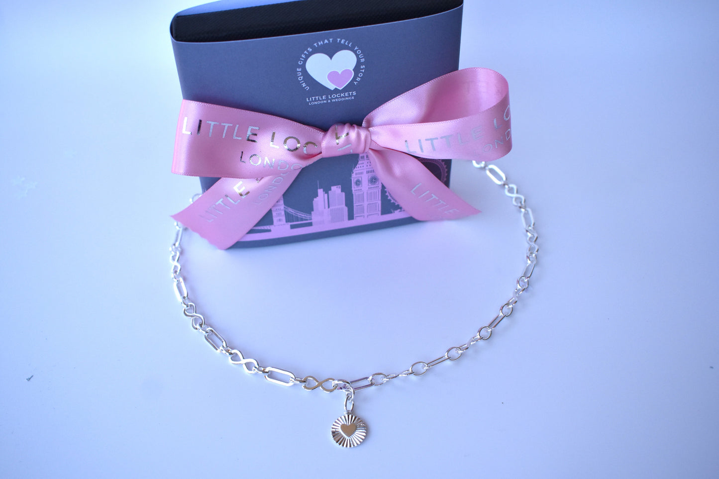 Sterling silver infinity link necklace with sunburst pendant