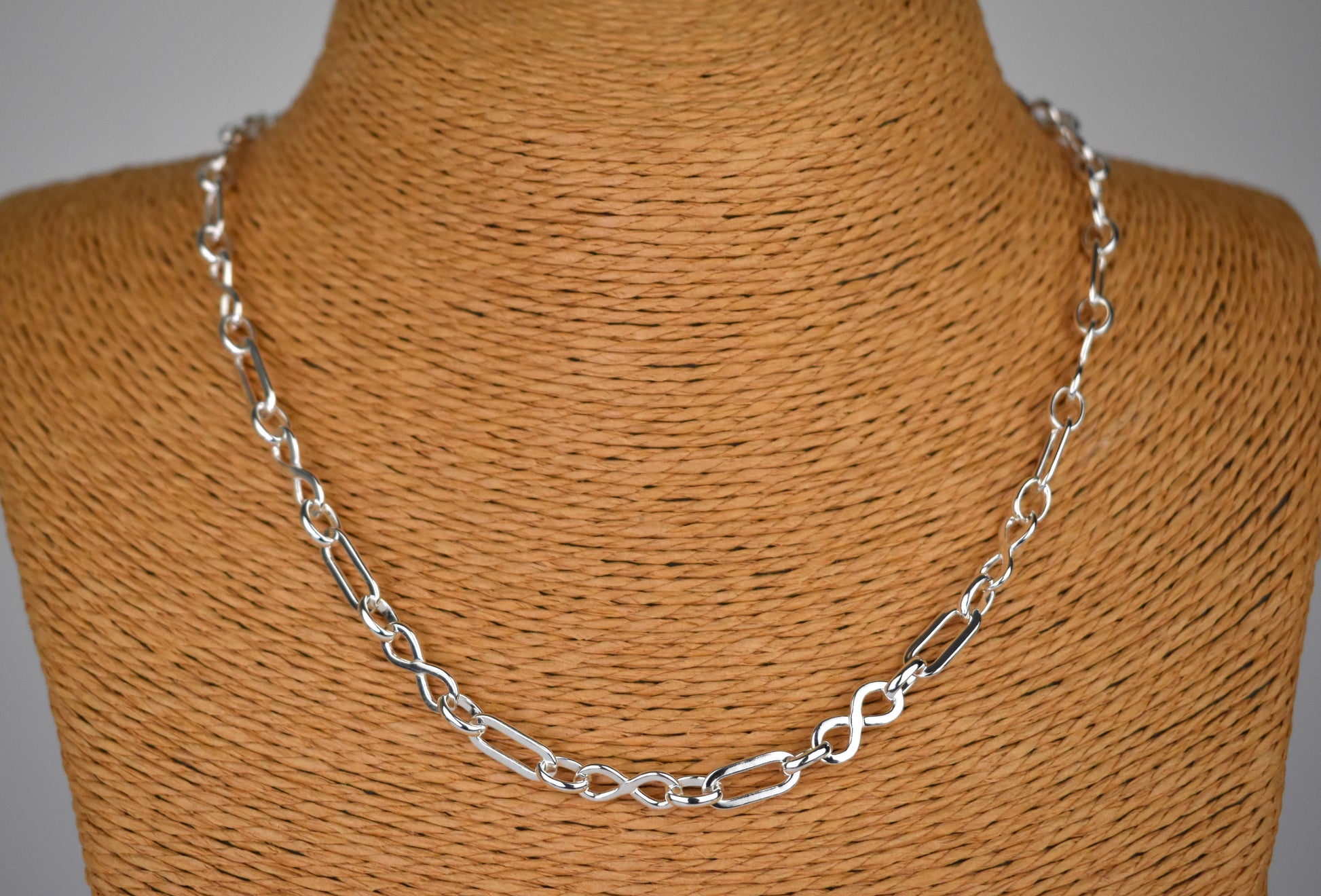 Sterling silver necklace of linked infinity symbols 