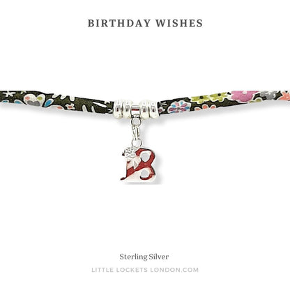 Liberty print adjustable bracelet with sterling silver beads and 18 charm, shown on card with the message "Birthday Wishes"