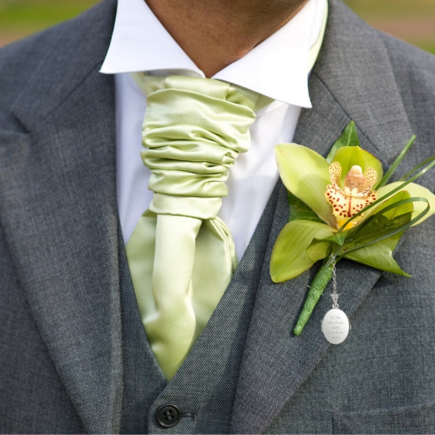 Man wears Engraved sterling silver oval photo locket on chain with t-bar fastening