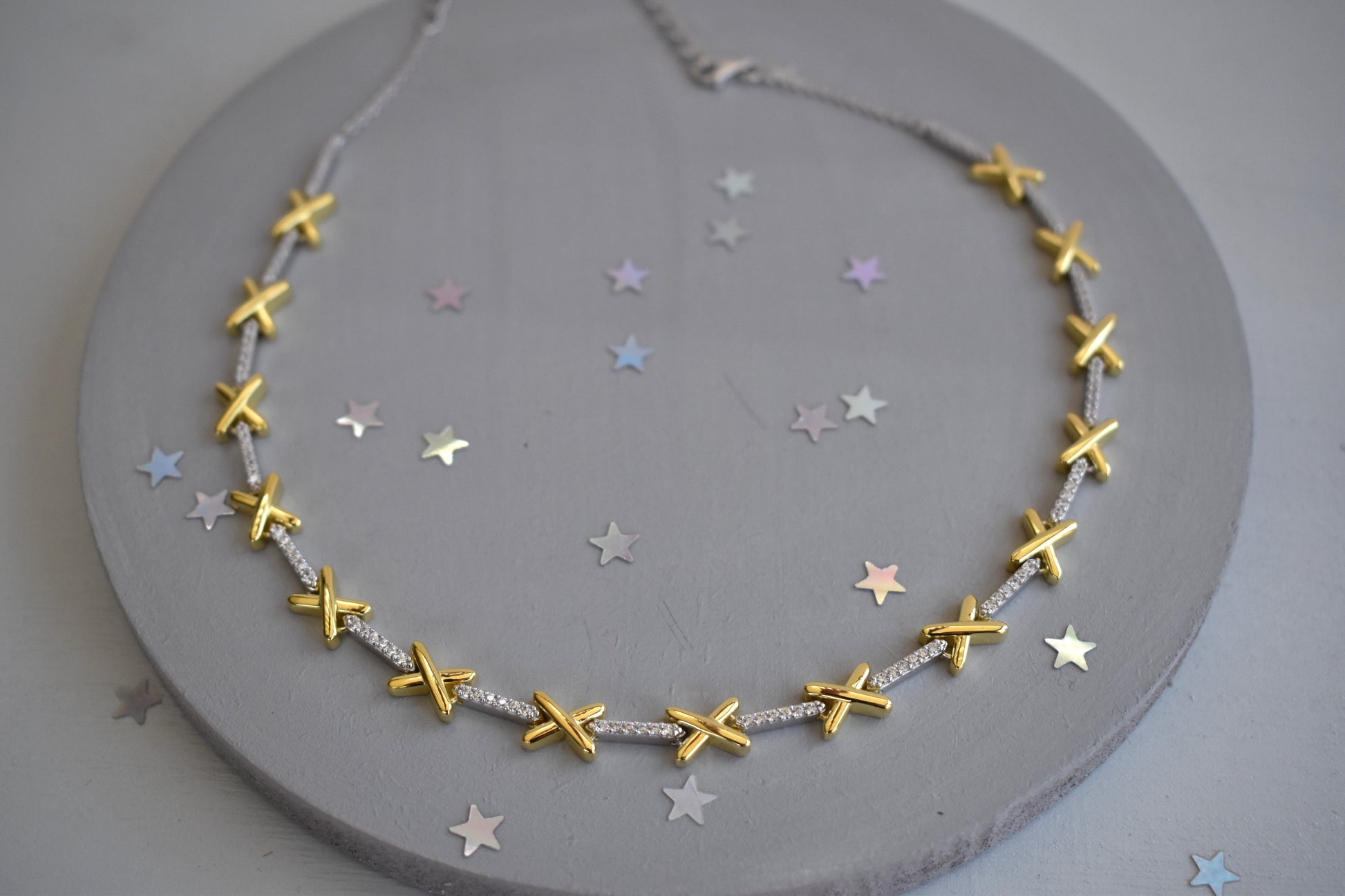The golden kisses necklace A delicate sterling silver necklace with golden kiss charms and sparkling CZ stones. 