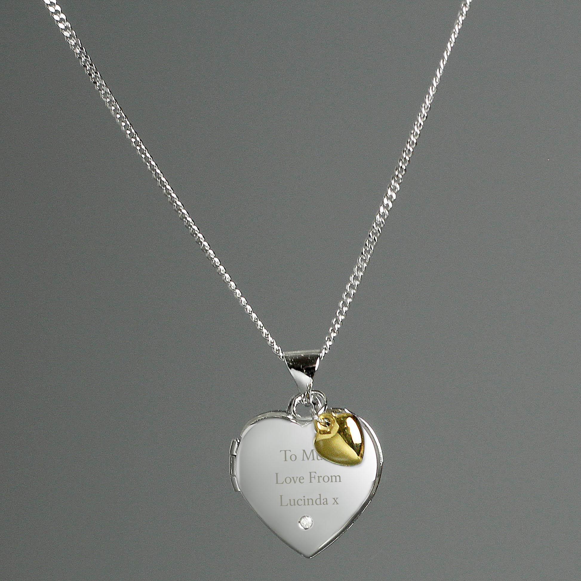 sterling silver heart shaped locket with engraved message and tiny gold heart