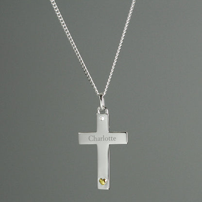 Sterling silver cross suspended from 18" sterling silver chain. The cross has a tiny zircona at the head and a gold plated heart at the foot of the cross. Personalised with a name of your choice.