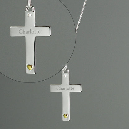 Close up detail of sterling silver chain with small zircona at the head of the cross and a tiny gold plated heart at the foot. Personalised with a name of your choice