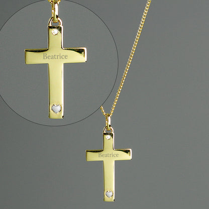 9CT gold plated sterling silver cross and chain, with a tiny zircona at the head of the cross and a small sterling silver heart at the base, the cross is suspended from an 18" gold plated chain and can be personalised with a name of your choice.