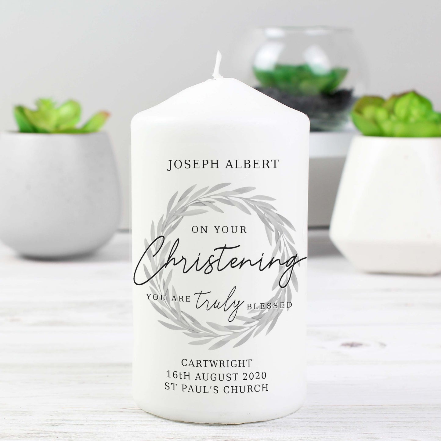 white christening candle which can be personalised with up to four lines of text, including the message "on your christening day you are truly blessed"
