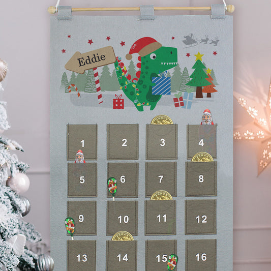 Felt advent calendar with cartoon dinosaur illustration and candy stripe sign personalised with a child's name 