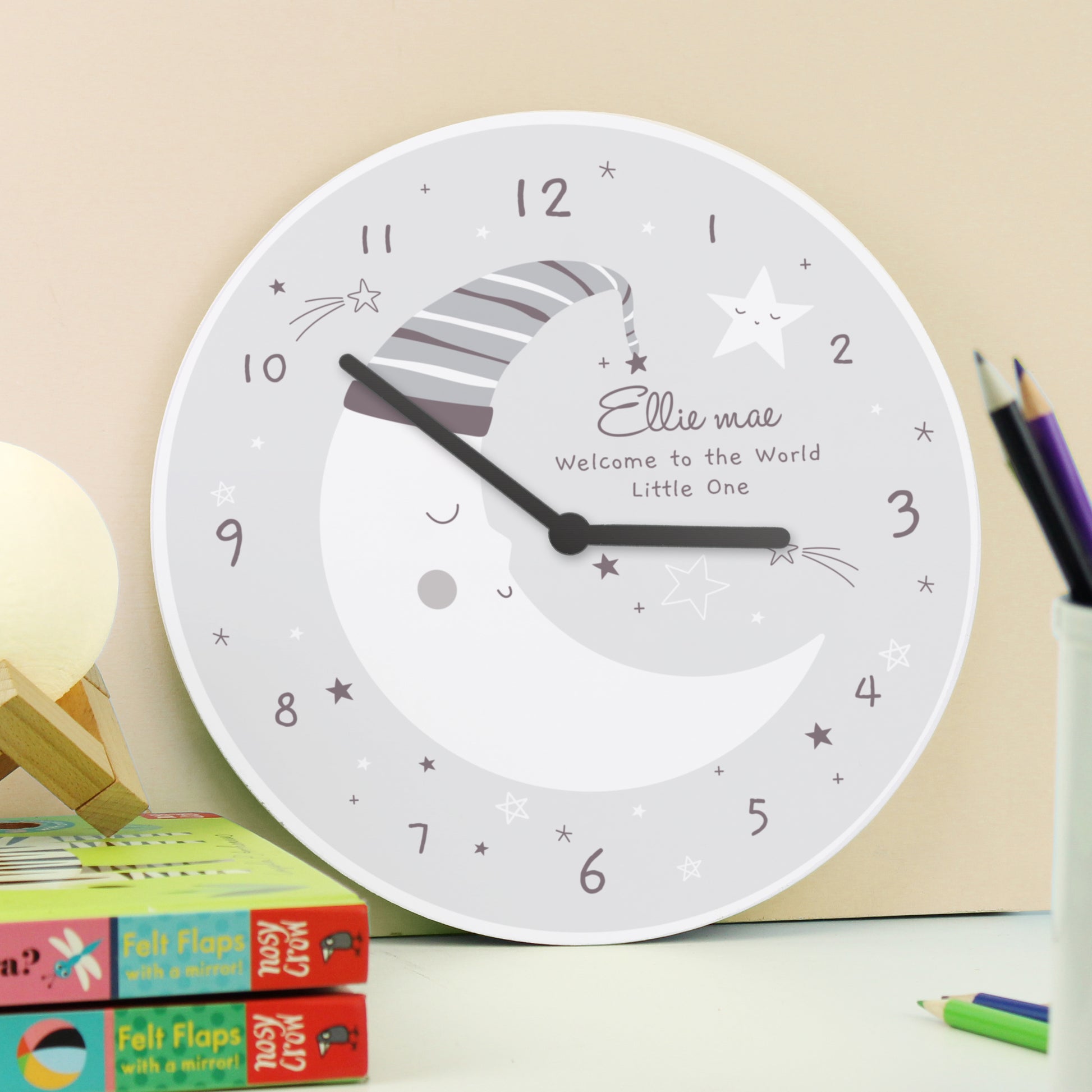 Wooden crescent moon clock with a sleepy moon and star design. Personalise with up to three lines of text.