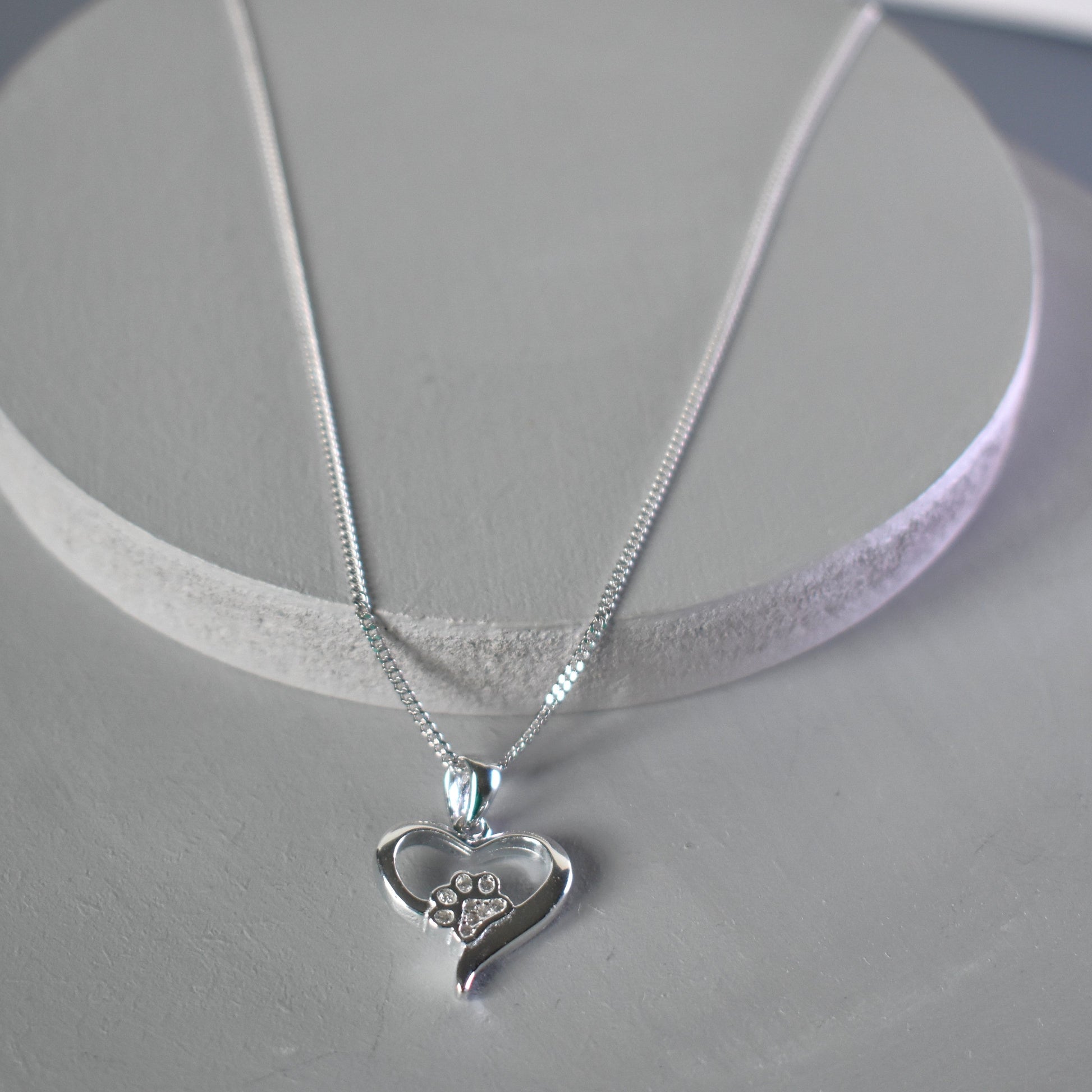 Silver heart shape necklace with crystal cubic zirconia paw print on 18" sterling silver diamond cut chain