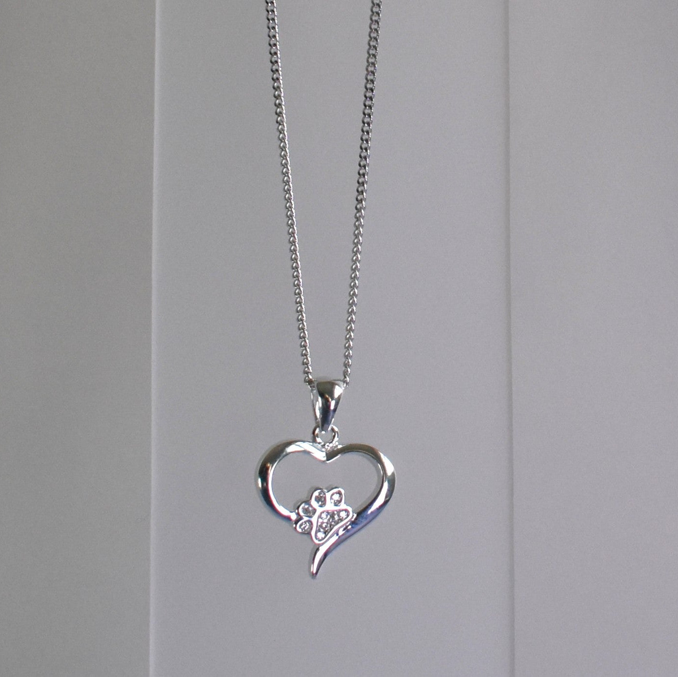 Silver heart shape necklace with crystal cubic zirconia paw print on 18" sterling silver diamond cut chain
