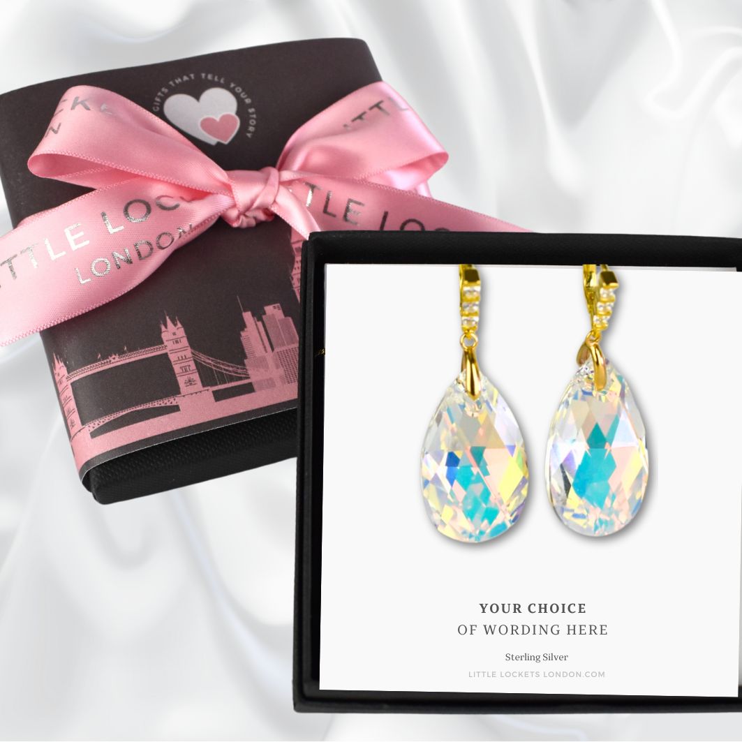 Crystal Pear drop earrings with gold plated sterling silver wires shown in gift box and a card with your choice of wording. Background shows optional upgraded gift wrap.