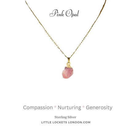 Pink opal raw crystal with sterling silver gold plated tip, suspended from a gold plated sterling silver chain. The opal is mounted on a card with the gem name and three of its qualities - compassion, nurturing and genorisity.