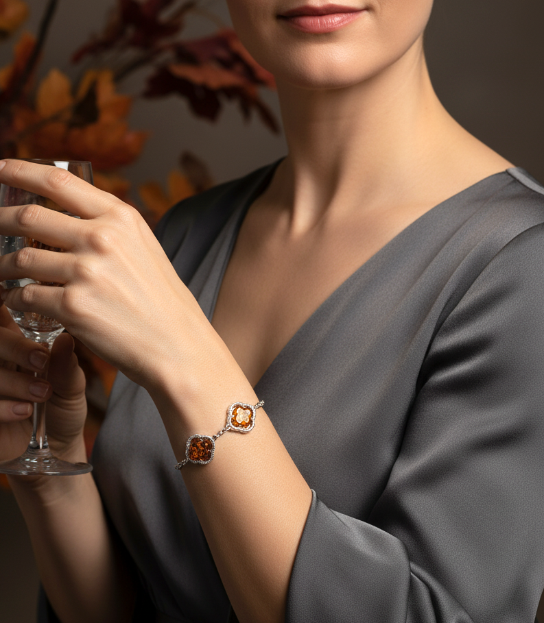 Amber trio bracelet consisting of three amber stones in a clover surround on a sterling silver bracelet. Shown worn.