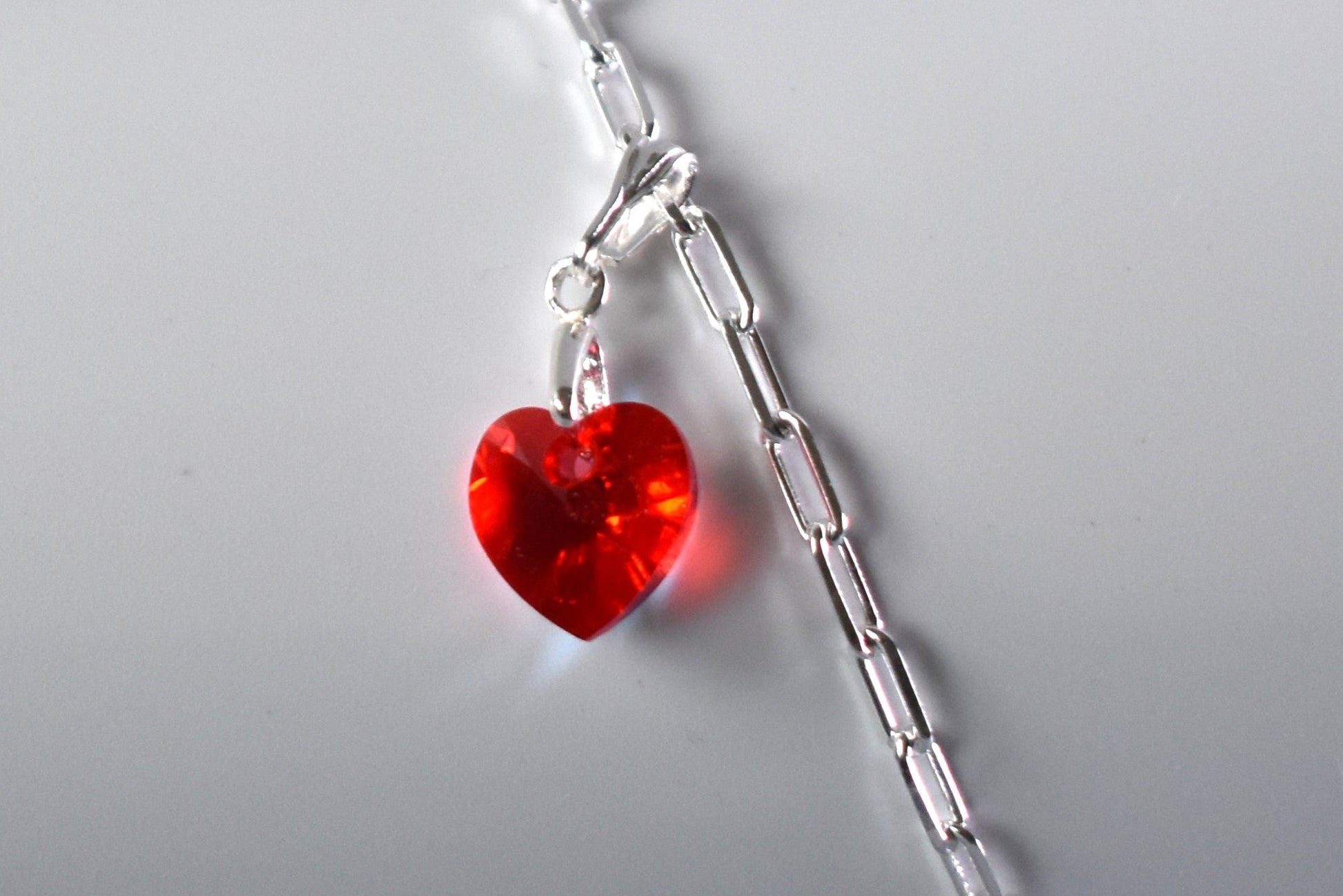 Sterling silver paperclip anklet with high quality crystal heart charm in your choice of colour.  Close up of heart