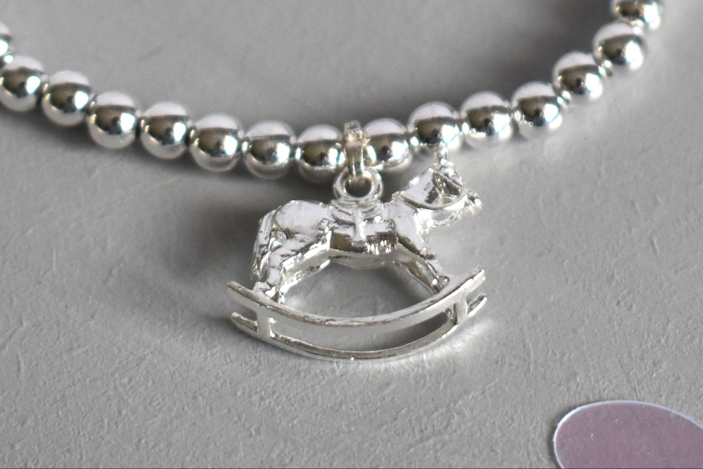 close up of the sterlig silver rocking horse is charm