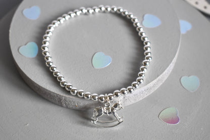 Silver bracelet with a rocking horse charm